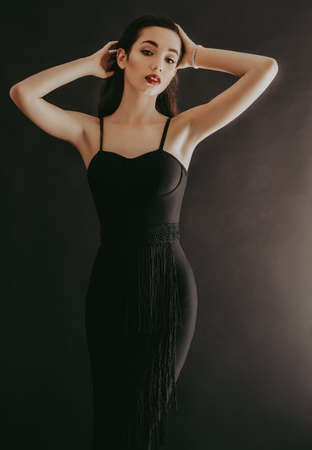 Portrait of beautiful brunette girl with makeup in fashion black clothesの写真素材
