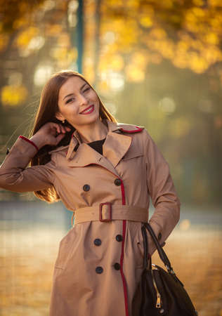 beautiful young woman in autumn parkの写真素材