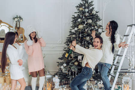 Portrait of four beautiful young girls is in Christmas sceneriesの写真素材