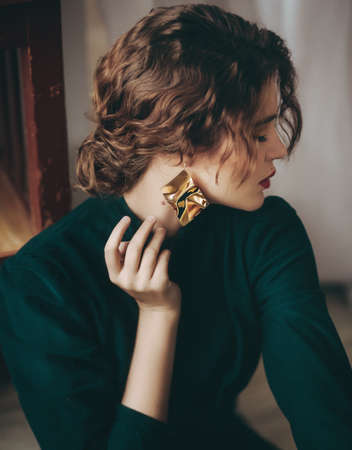 Portrait of a beautiful young woman in green dress