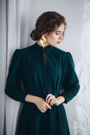 Portrait of a beautiful young woman in green dressの写真素材