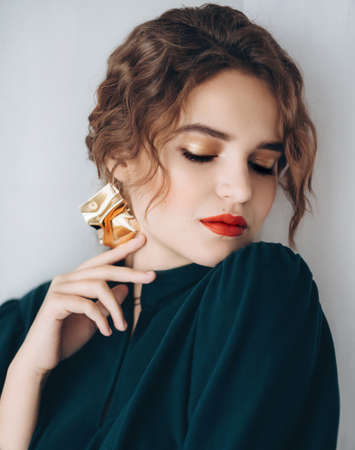 Portrait of a beautiful young woman in green dressの写真素材