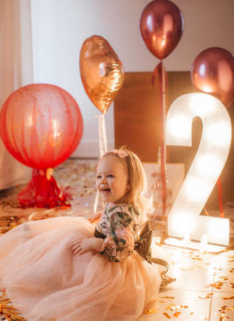Beautiful little girl celebrating birthday party.の写真素材