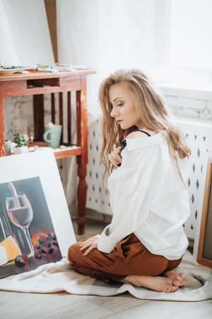 Portrait of beautiful young blonde woman with makeup in fashion clothesの写真素材