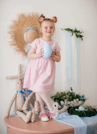 Cute little girl with a bunny rabbit at Easter.