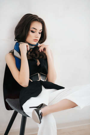 Portrait of beautiful brunette girl with makeup in fashion clothesの写真素材