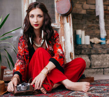 Portrait of beautiful young brunette woman with makeup in bright clothing