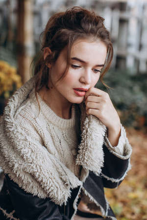 Beautiful girl in autumn garden with yellow flowersの写真素材