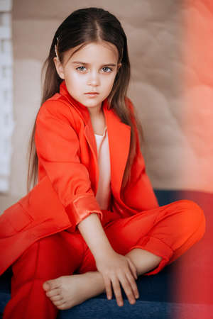 Little happy girl in red fashion clothes