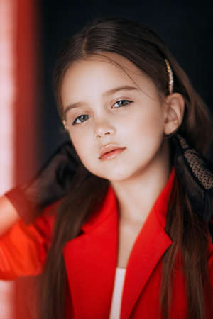 Little happy girl in red fashion clothes