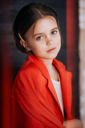 Little happy girl in red fashion clothesの写真素材