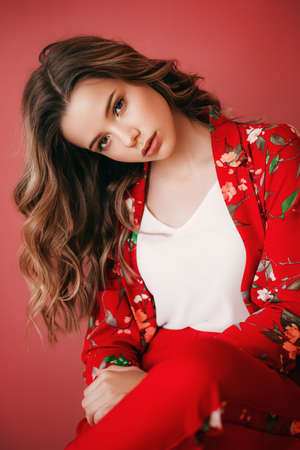 Portrait of beautiful girl with makeup in fashion red clothes