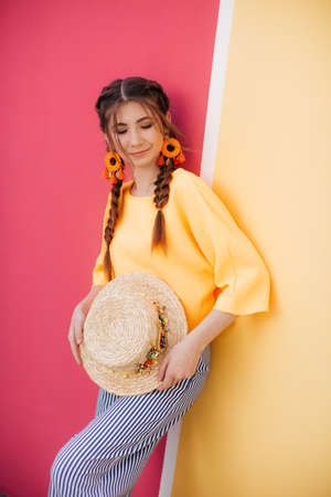 Portrait of beautiful girl with makeup with braids in hatの写真素材