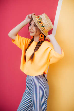 Portrait of beautiful girl with makeup with braids in hatの写真素材