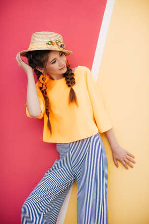 Portrait of beautiful girl with makeup with braids in hatの写真素材