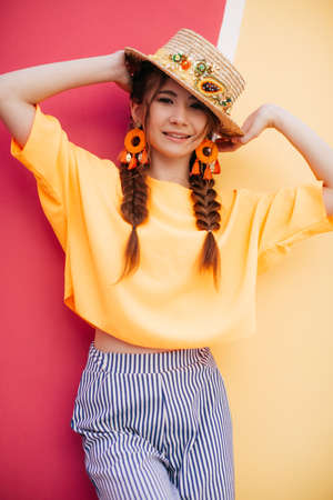 Portrait of beautiful girl with makeup with braids in hatの写真素材