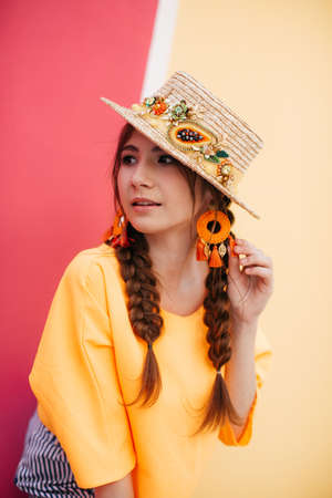 Portrait of beautiful girl with makeup with braids in hatの写真素材