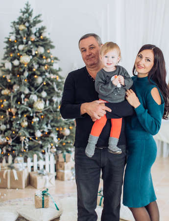 Happy little girl with mom and dad among the New Year's scenery