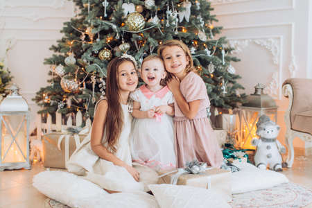Beautiful portrait of three sisters in Christmas decorationsの写真素材