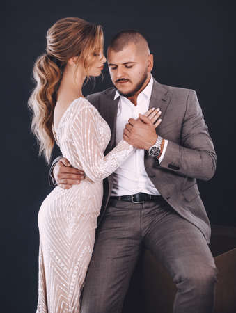 Stock Photo - Portrait of beautiful young wedding couple at black backgroundの写真素材