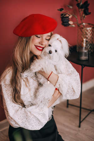 Beautiful fashion model in red hat, Red lipstick. Portrait of glamor blonde girl with bright makeup.の写真素材
