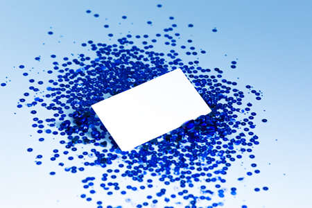 Stock Photo - Photo of blank card with blue sequins on  paper background. For design presentations...