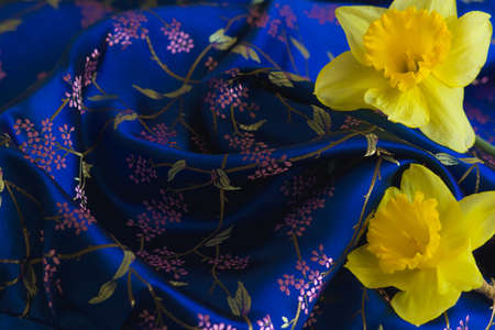Luxury blue silk with yellow flowers.の写真素材