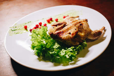 Stock Photo - Grilled fried roast Chicken Tabaka on a white plateの写真素材