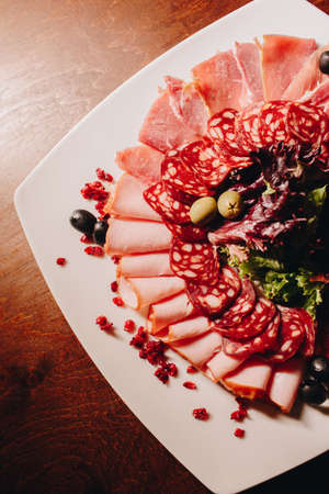 Stock Photo - Meat plate: sausage, bacon, savory appetizers and saucesの写真素材