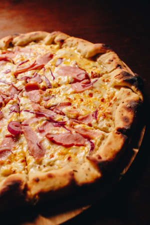 Stock Photo - Fresh delicious Italian pizza on a dark backgroundの写真素材