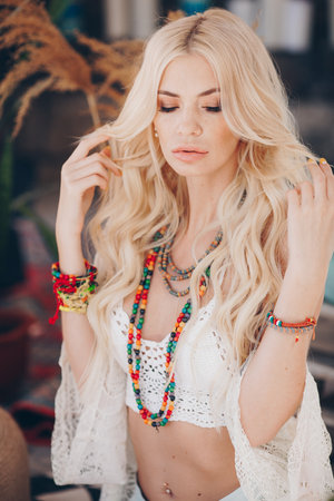 Portrait of beautiful young blonde in the white clothing of style of bohoの写真素材