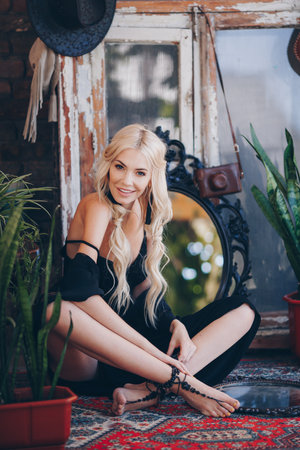 Portrait of beautiful young blonde in the white clothing of style of bohoの写真素材