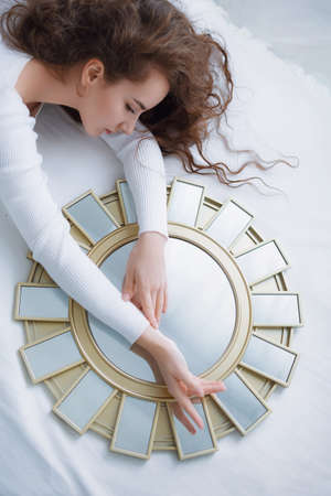 Stock photo - Girl under the covers in her bedの写真素材