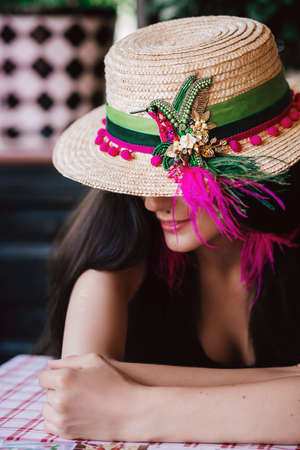 Young attractive girl in a handmade chic hatの写真素材