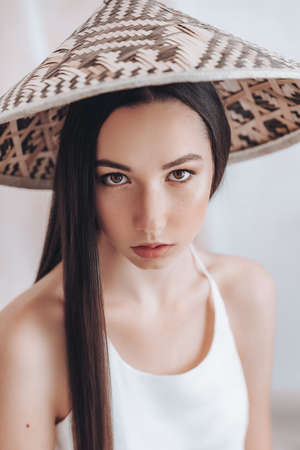 Portrait of beautiful young girl with natural beauty. Girl in bamboo vietnamese hatの写真素材