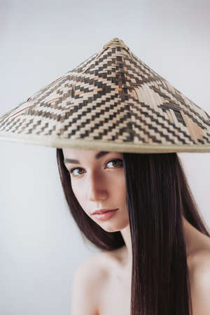 Portrait of beautiful young girl with natural beauty. Girl in bamboo vietnamese hatの写真素材