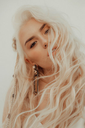 Portrait of beautiful young blonde in the white clothing of style of bohoの写真素材