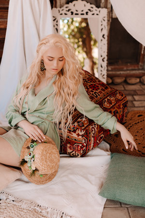 Portrait of beautiful young blonde in the white clothing of style of bohoの写真素材