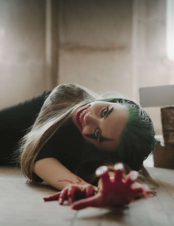 Young woman with Joker makeup and costume. Cosplay photoの写真素材