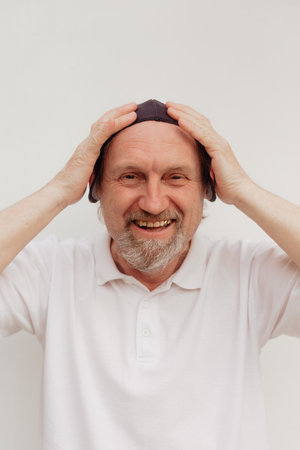 Stock Photo - Senior man in a white t-shirt wearing medical mask