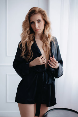 Gorgeous beautiful girl is in elegant black pajamas. Trend of 2021 Natural female beauty.の写真素材