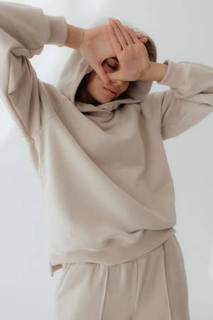 Ukrainian  young  woman in sweatshirt mock up on light background. Female body and style concept....