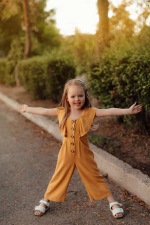 Closeup portrait of a little baby girl on wheat summer field. happy childhood concept. Adventure, travel, tourism, hike and people concept - happy family walkingの写真素材