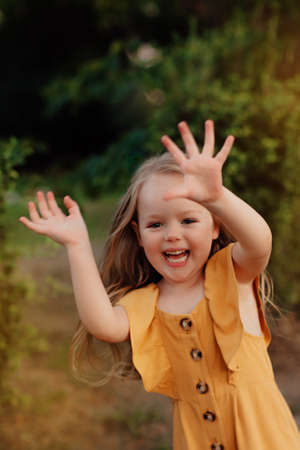 Closeup portrait of a little baby girl on wheat summer field. happy childhood concept. Adventure,...