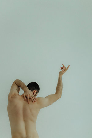 People, healthcare and problem concept - man suffering from back pain or reins. Close up hands...