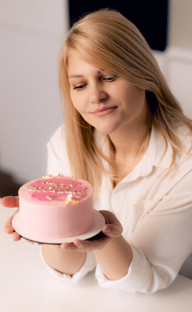 Pastry chef confectioner young caucasian woman in the kitchen.