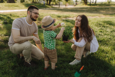 Summer sunny day for a young family, dad, mom and little son became joyful and happy. Happy family concept photo. No focus blurred and noise effectの写真素材