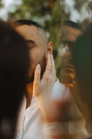 Close up of a beautiful young happy couple in love embracing while spending time in the park. The concept of a happy relationship in marriage. No focus blurred and noise effect.の写真素材