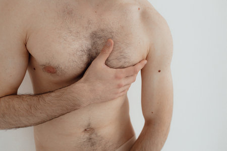 People, healthcare and problem concept - man suffering from back pain or reins. Close up hands...