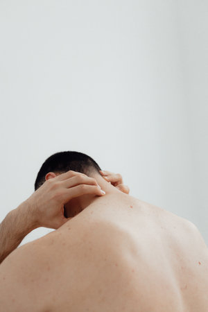 People, healthcare and problem concept - man suffering from pain or reins. Close up hands touching pain. Man standing on white background. No focus blurred and noise effect.の写真素材